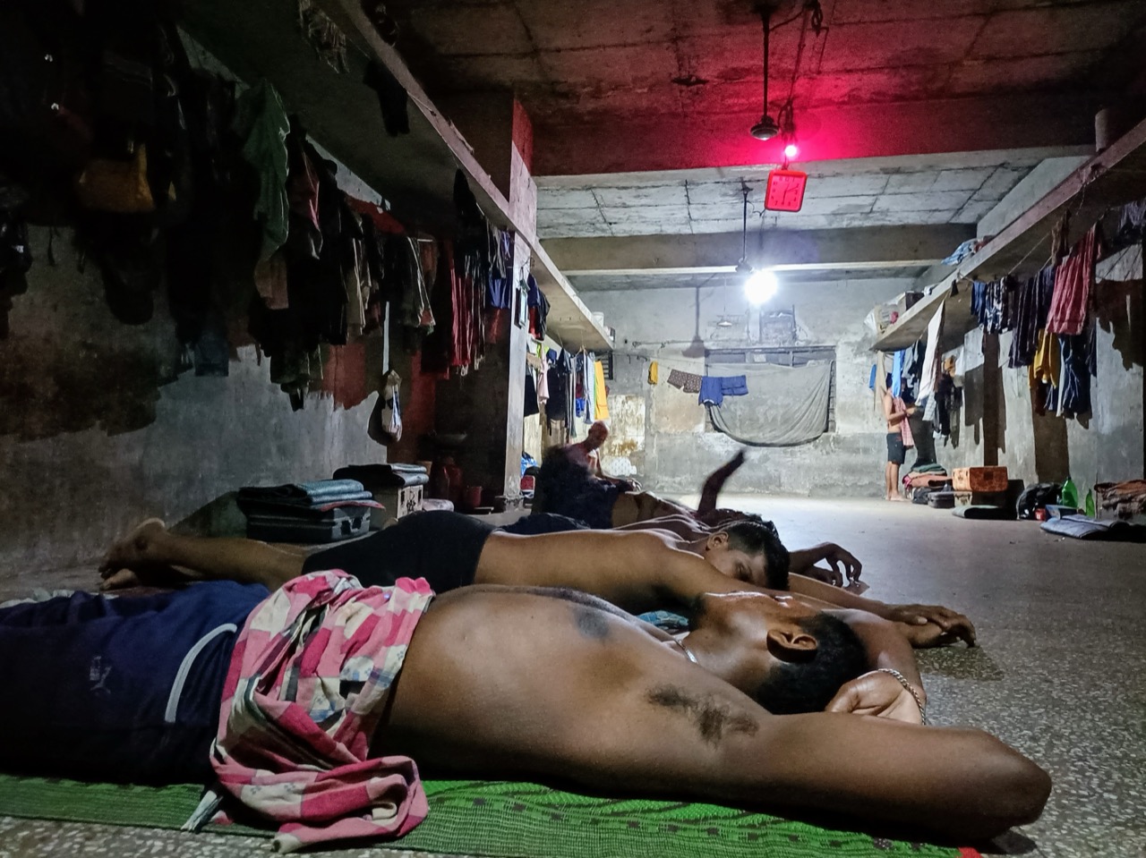 Migrant workers resting in a mess room.